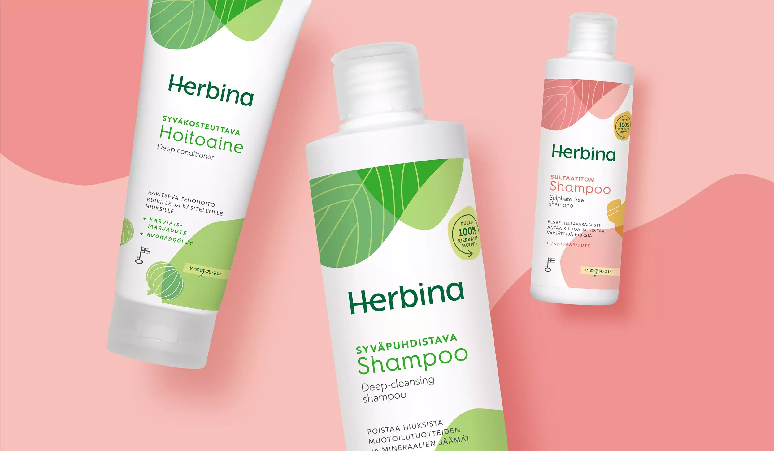 Herbinan pakkausuudistus: kosteuttava shampoo, sulfaatiton shampoo ja kosteuttava hoitoaine vaaleanpunaisella pohjalla